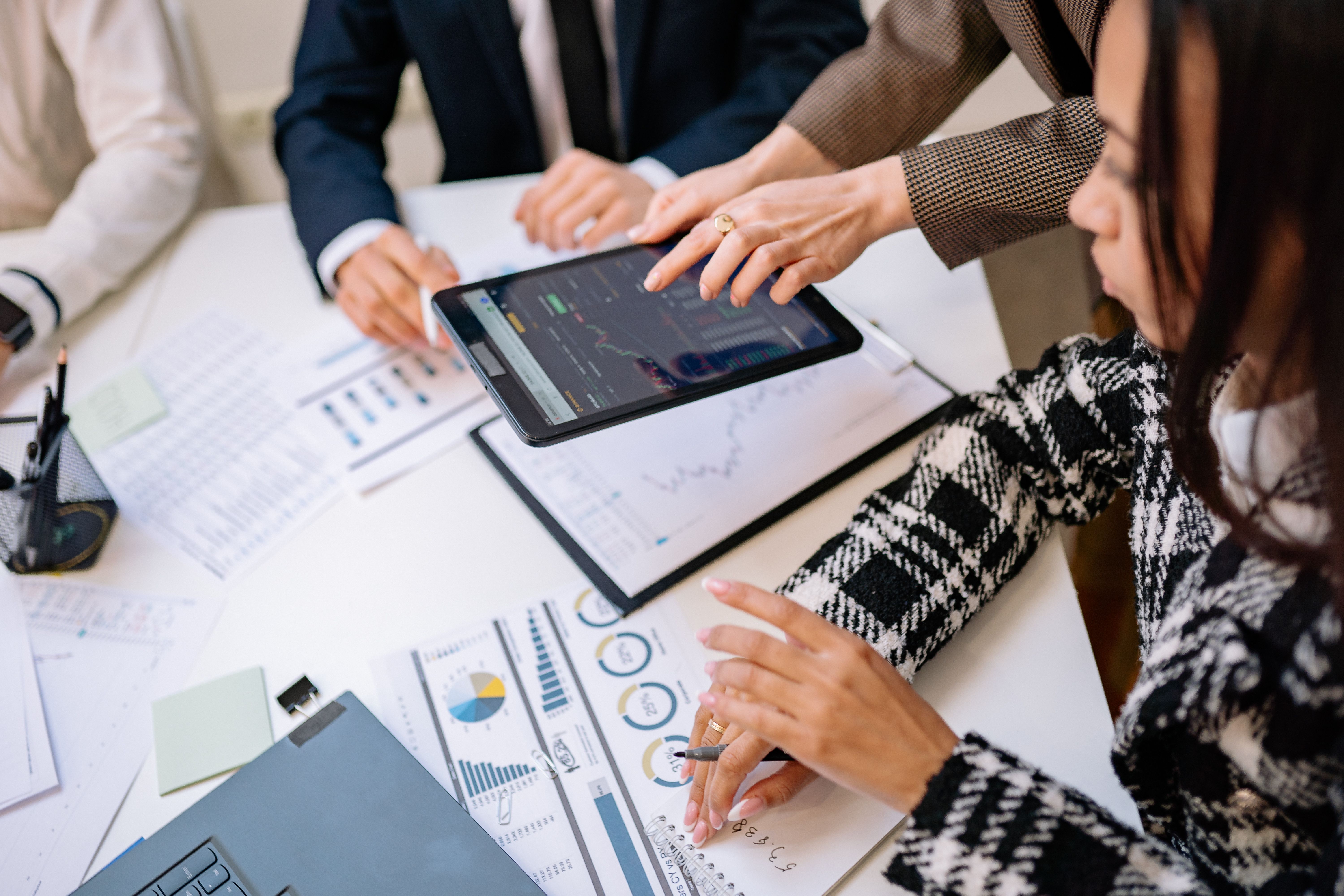 Business team reviewing analytics on a tablet